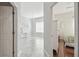 Hallway leading to bedroom and formal living areas featuring tile floors and natural light at 2919 Northfield Dr, Tarpon Springs, FL 34688