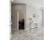 Inviting hallway with marble floors, chandelier, and tasteful console table, perfect for welcoming guests at 2919 Northfield Dr, Tarpon Springs, FL 34688
