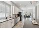 Bright kitchen with stainless steel appliances, white cabinets, and open to dining area at 2919 Northfield Dr, Tarpon Springs, FL 34688
