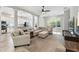 Spacious living room with an open floor plan, large windows, and carpet flooring at 2919 Northfield Dr, Tarpon Springs, FL 34688
