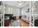 Inviting home office space with hardwood floors and a comfortable seating area at 2919 Northfield Dr, Tarpon Springs, FL 34688