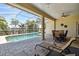 Relaxing patio with pool, covered seating area, and tranquil views at 2919 Northfield Dr, Tarpon Springs, FL 34688