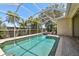 Enjoy this beautiful screened-in pool and spa surrounded by lush, tropical landscaping, perfect for relaxing or entertaining at 2919 Northfield Dr, Tarpon Springs, FL 34688