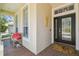 Welcoming front porch features a cozy bench, decorative details, and double doors to the home at 2919 Northfield Dr, Tarpon Springs, FL 34688