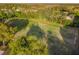 Areal shot of a well-kept soccer field with goals and players surrounded by trees, forming an ideal community recreation area at 2919 Northfield Dr, Tarpon Springs, FL 34688