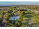 Aerial view of the sports field, basketball court and community in a lush green, serene neighborhood with lake views at 2919 Northfield Dr, Tarpon Springs, FL 34688