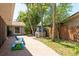 View of the backyard with mature landscaping, pizza oven and patio, a perfect retreat for outdoor living at 3647 Scarlet Tanager Dr, Palm Harbor, FL 34683