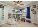 bedroom featuring a bunk bed with slide, ceiling fan, window with blinds and playful decor at 3647 Scarlet Tanager Dr, Palm Harbor, FL 34683