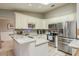 Bright kitchen featuring stainless steel appliances, granite countertops, tile backsplash, and ample cabinet space, ideal for cooking at 3647 Scarlet Tanager Dr, Palm Harbor, FL 34683