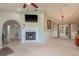 Cozy living room with a fireplace, neutral walls, and access to the backyard through glass doors, creating a warm atmosphere at 3647 Scarlet Tanager Dr, Palm Harbor, FL 34683