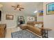 Comfortable living room with a plush sofa, ceiling fan, and access to the patio, perfect for relaxing and entertaining at 3647 Scarlet Tanager Dr, Palm Harbor, FL 34683