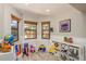 Bright playroom featuring multiple windows, neutral walls, and colorful toys, creating an inviting space for children at 3647 Scarlet Tanager Dr, Palm Harbor, FL 34683
