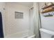 Modern bathroom features tiled shower, contemporary fixtures and a decorative wall inset for a relaxing atmosphere at 3647 Scarlet Tanager Dr, Palm Harbor, FL 34683