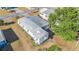 Aerial view of a well-maintained single-story home with a metal roof at 37229 Cora Ave, Zephyrhills, FL 33542
