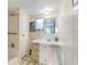Cozy bathroom featuring a single vanity, tiled walls, and a shower-tub combination at 37229 Cora Ave, Zephyrhills, FL 33542