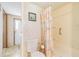 Modest bathroom with a patterned shower curtain, white toilet, and linoleum flooring at 37229 Cora Ave, Zephyrhills, FL 33542