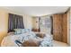 Comfortable bedroom featuring a cozy bed, natural light, and a closet for storage at 37229 Cora Ave, Zephyrhills, FL 33542