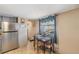 Bright dining area with a view, complemented by a modern lighting fixture at 37229 Cora Ave, Zephyrhills, FL 33542