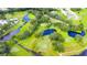 Aerial view of the golf course featuring lush green fairways, water features, and mature trees at 37229 Cora Ave, Zephyrhills, FL 33542