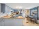 Efficient kitchen with stainless steel appliances, wood countertops, and adjacent dining area at 37229 Cora Ave, Zephyrhills, FL 33542