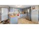 Well-lit kitchen equipped with stainless steel appliances, ample counter space, and modern finishes at 37229 Cora Ave, Zephyrhills, FL 33542