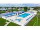 Stunning community pool area with multiple pools, lounge chairs, and a lake view with an American flag at 37229 Cora Ave, Zephyrhills, FL 33542