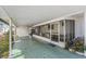 Covered porch featuring a seating area, tile flooring, and bright lighting at 37229 Cora Ave, Zephyrhills, FL 33542