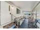 Screened-in porch with comfortable seating arrangements at 37229 Cora Ave, Zephyrhills, FL 33542