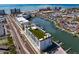 Wonderful aerial shot showcasing a luxury waterfront residence near a tranquil marina and a vibrant coastal community at 400 150Th Ave # 506, Madeira Beach, FL 33708