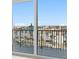 A balcony with railings and a view of the neighborhood with a blue sky above at 400 150Th Ave # 506, Madeira Beach, FL 33708