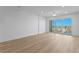 Spacious bedroom featuring stylish, light-colored flooring and sliding glass doors to the balcony at 400 150Th Ave # 506, Madeira Beach, FL 33708