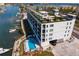 Exterior angle featuring building, swimming pool, boat parking, and rooftop terrace at 400 150Th Ave # 506, Madeira Beach, FL 33708