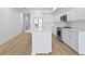 Modern kitchen featuring white cabinetry, stainless steel appliances, and a large center island at 400 150Th Ave # 506, Madeira Beach, FL 33708