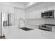 Bright kitchen featuring stainless steel appliances, quartz countertops and white cabinetry at 400 150Th Ave # 506, Madeira Beach, FL 33708