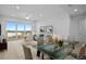Living area featuring a sliding glass door to a balcony with water views, open to the dining area at 400 150Th Ave # 506, Madeira Beach, FL 33708