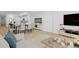 Bright, open-concept living room featuring modern furnishings and an adjacent dining area at 400 150Th Ave # 506, Madeira Beach, FL 33708