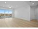 Open living room featuring hardwood floors, modern windows and an airy floorplan at 400 150Th Ave # 506, Madeira Beach, FL 33708