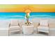 Stylish lobby seating area features neutral furniture, a beach mural, and elegant decor at 400 150Th Ave # 506, Madeira Beach, FL 33708