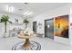 Inviting lobby with elegant chandelier, palm trees, and elevator access at 400 150Th Ave # 506, Madeira Beach, FL 33708