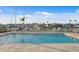 Community pool with lounge chairs and views of the harbor at 400 150Th Ave # 506, Madeira Beach, FL 33708