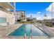 Community pool deck with lounge chairs and marina views at 400 150Th Ave # 506, Madeira Beach, FL 33708