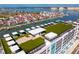 An aerial view of the Residences showcasing its rooftop deck, lounge spaces, and marina views at 400 150Th Ave # 506, Madeira Beach, FL 33708