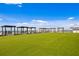 Expansive rooftop terrace featuring modern pergola lounge areas and lush green turf at 400 150Th Ave # 506, Madeira Beach, FL 33708