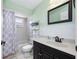 Bright bathroom with a shower-tub combo, white vanity, and a framed mirror at 4124 Pine Dale Ct, Hernando Beach, FL 34607
