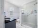 Modern bathroom featuring a glass-enclosed shower, granite countertop, and white tile flooring at 4124 Pine Dale Ct, Hernando Beach, FL 34607