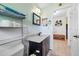 Neat bathroom with a dark vanity, white countertops, and shelving for storage at 4124 Pine Dale Ct, Hernando Beach, FL 34607