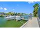 Waterfront dock with a boat lift, ideal for boating and enjoying the water views at 4124 Pine Dale Ct, Hernando Beach, FL 34607