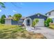 Charming one-story home featuring a stone accent wall, manicured lawn, and an attached single-car garage at 4124 Pine Dale Ct, Hernando Beach, FL 34607