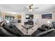Spacious living room with neutral tile floors, lots of natural light, and an open layout to the dining area at 4124 Pine Dale Ct, Hernando Beach, FL 34607