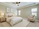 Bright bedroom featuring tray ceiling, ceiling fan, neutral color palette, and stylish furnishings at 4975 Night Star Trl, Odessa, FL 33556